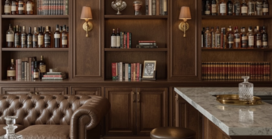Classic-modern home whiskey lounge with dark wood shelves, tufted leather sofa, marble bar, and warm lighting.