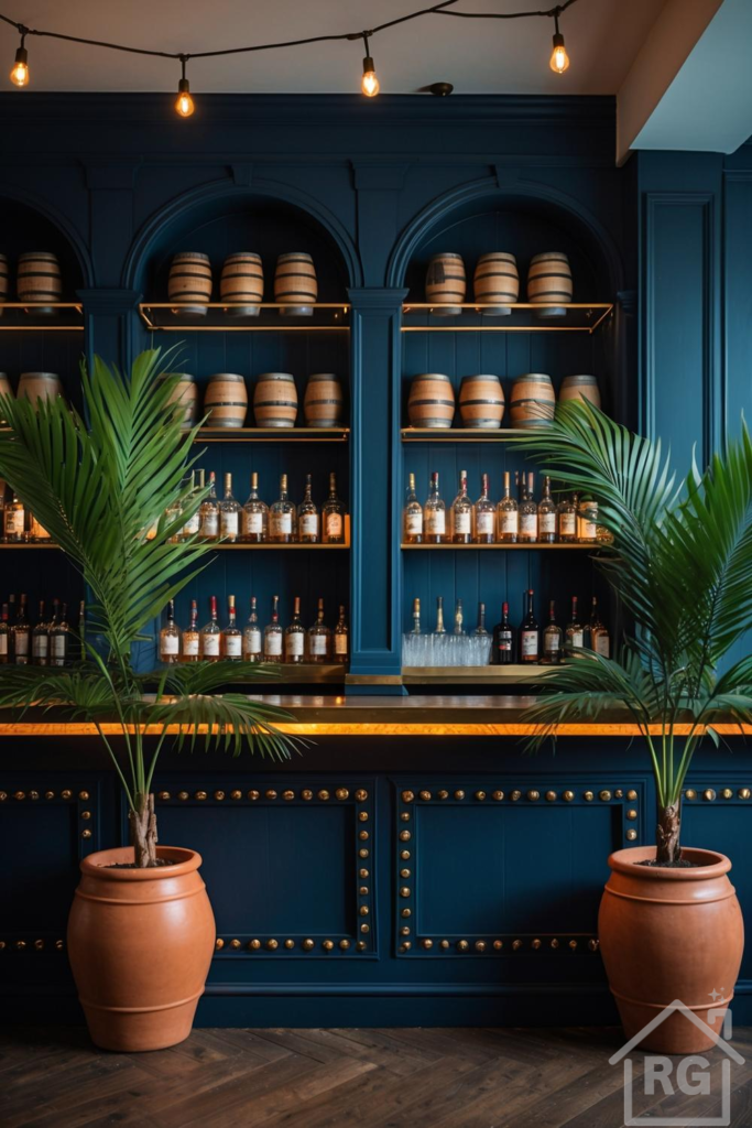 A luxurious navy blue rum bar featuring built-in shelving filled with liquor bottles and decorative wooden barrels. Two large palm plants in terracotta pots flank the bar, which is illuminated by warm string lights and a golden counter.